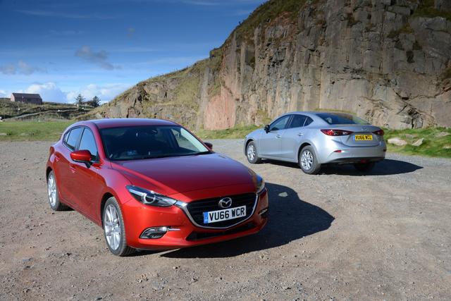 two mazda 3s; one red and one silver