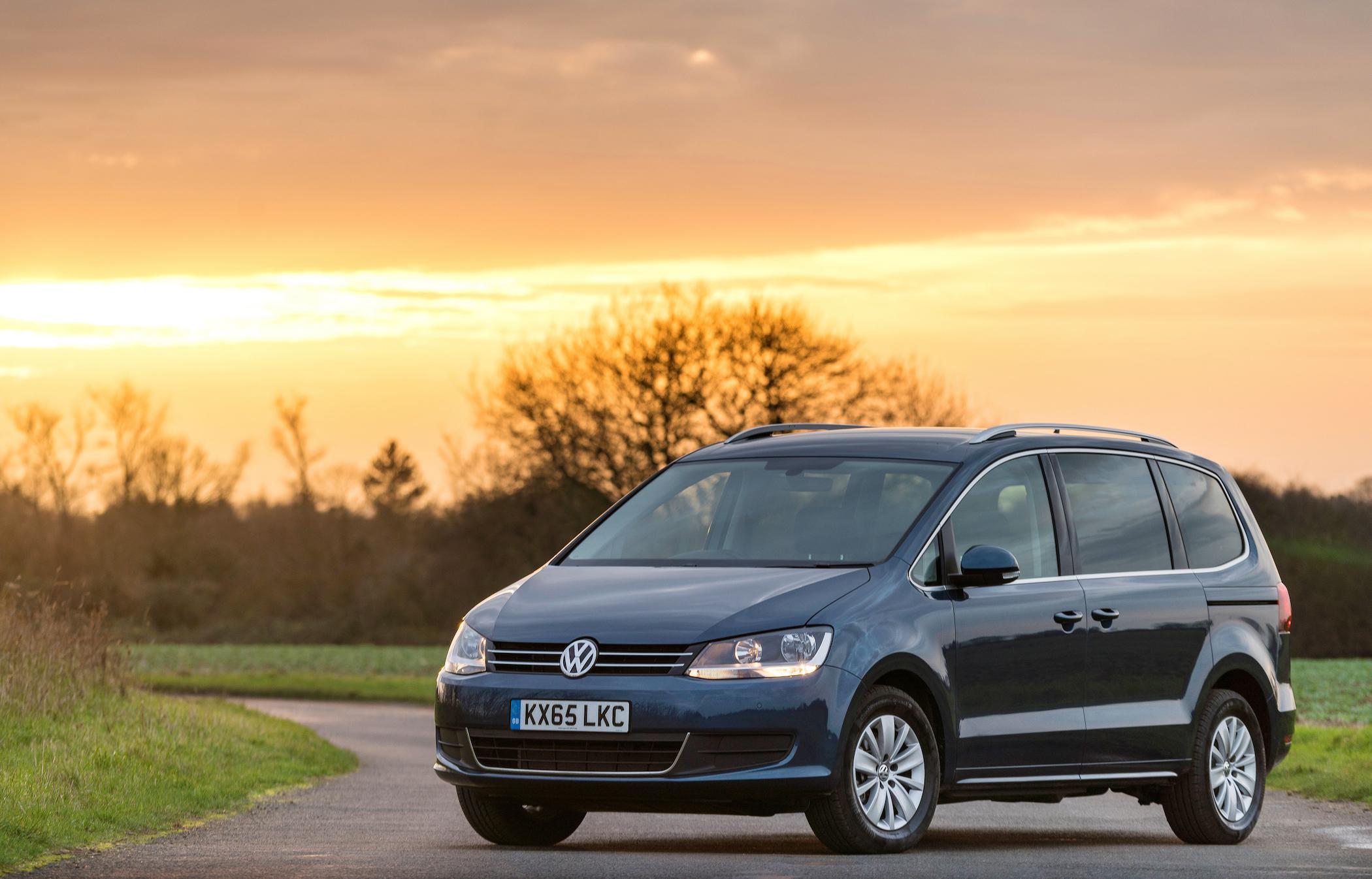 blue volkswagen sharan parked on the road in front of the sunset