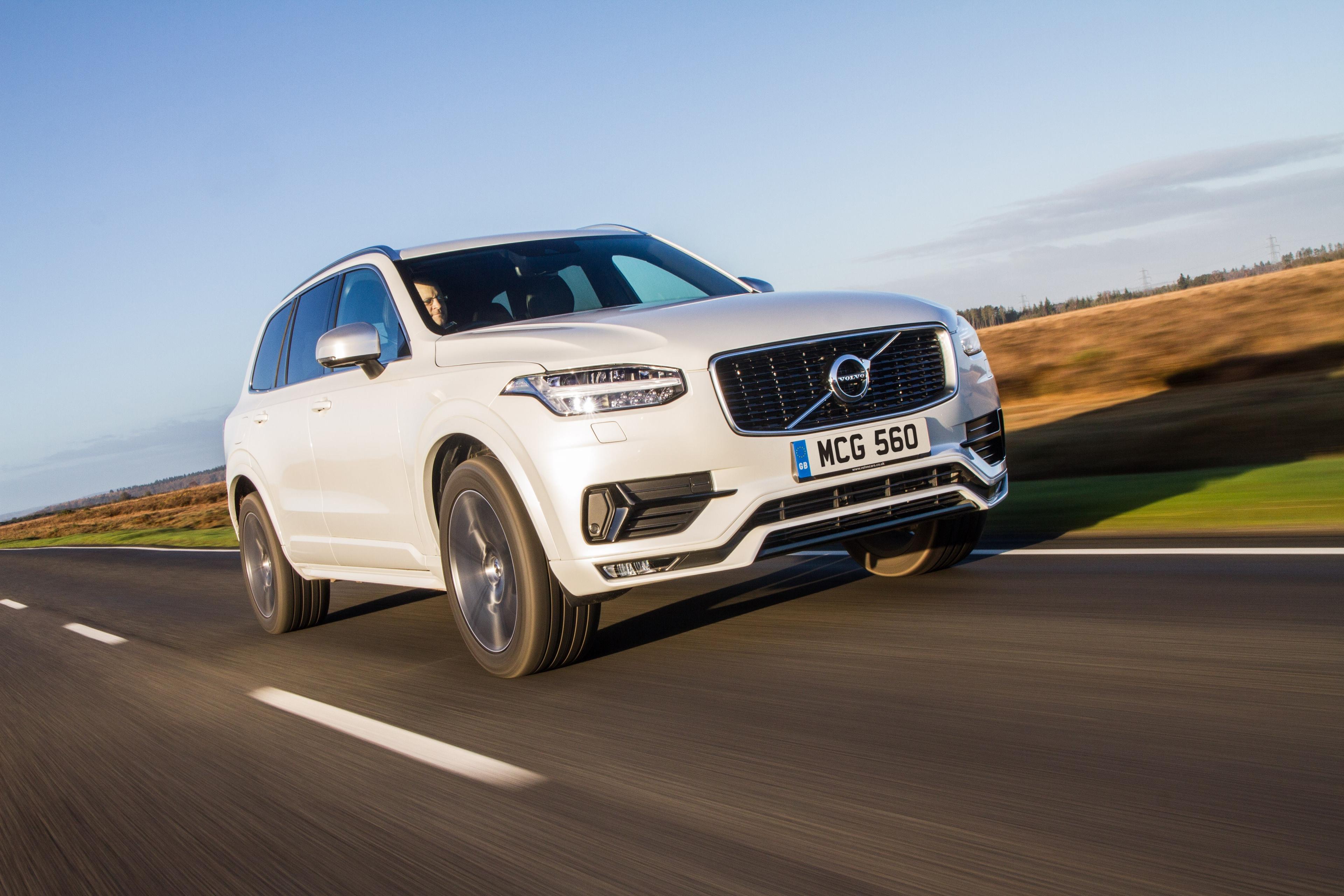 white volvo xc90 driving on the road