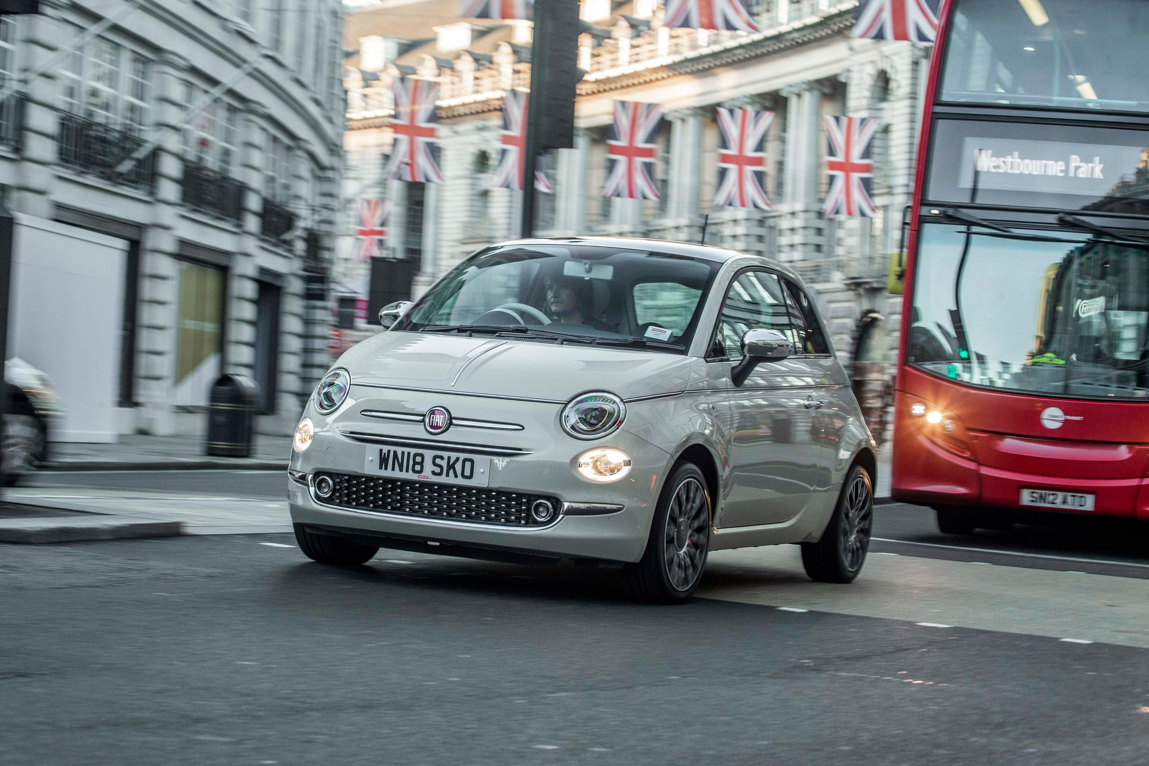 white fiat 500 driving in london